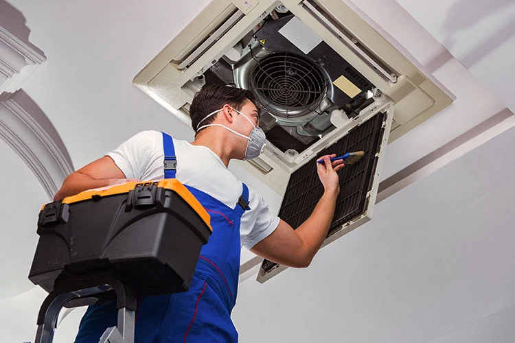 Technician installing air conditioner at Kwiks System and Services, Ashokapuram